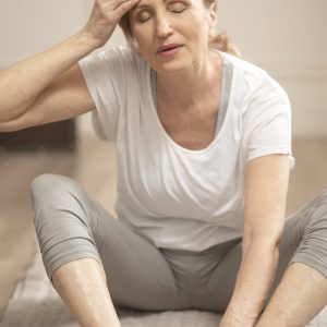 cheerful-middle-aged-woman-relaxing-after-making-yoga-exercises-min